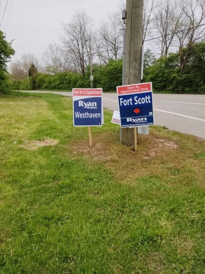 Ryan Homes Westhaven and Fort Scott yard signs along a roadside
